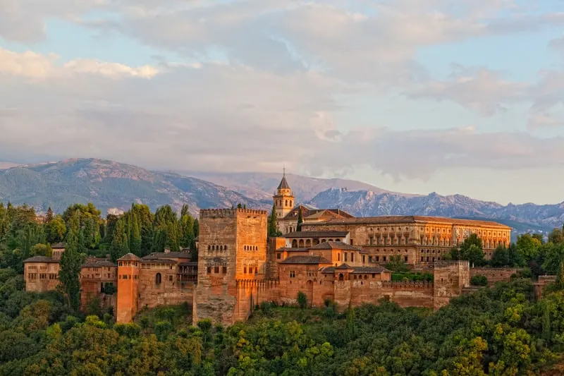 view of the ancient arabic fortress of Alhambra in Granada during sunset