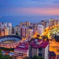 an aerial view of the malaga cityscape during sunset
