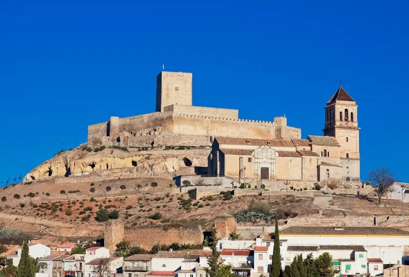 a view of an old castle, church, and sky in Jaen