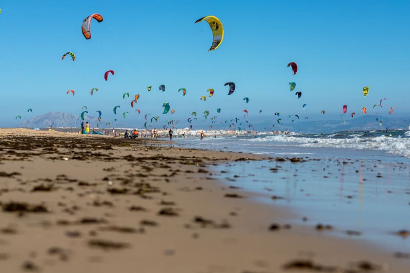 The beach at Tarifa on a summer day in August with the kitesurfers out.