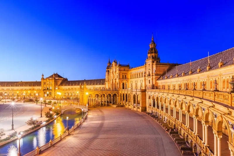 The amazing Plaza de España in Seville, Spain at night with street lights turned on