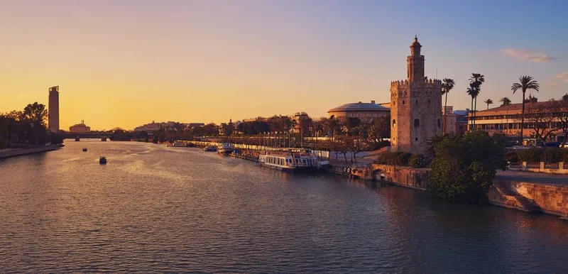 Rio Guadalquivir at sunset and Navigation Pavilion, Seville in June