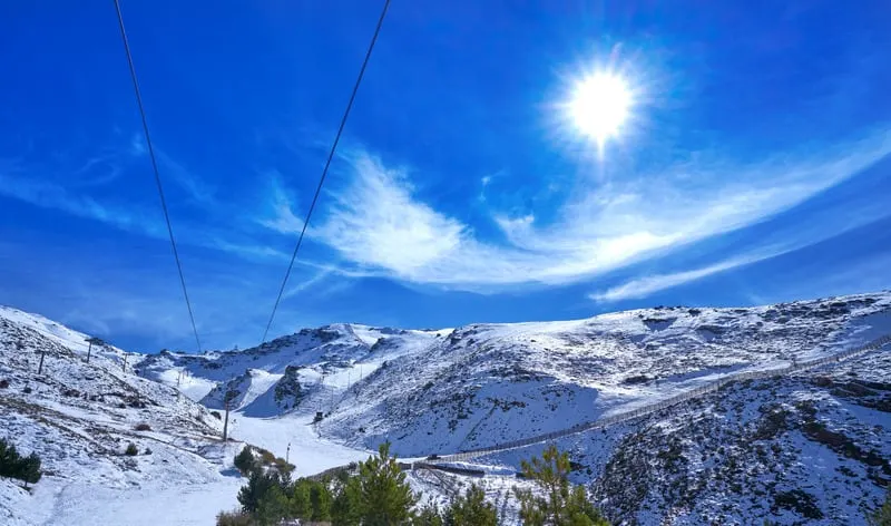 a view of snowy mountains on the bright sunny day