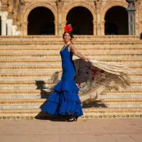3-day itinerary Seville, Flamenco show, a woman in the street near a plaza dancing to Flamenco