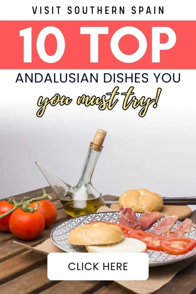 A table with a plate and food on it. Bread, tomatoes, cold cuts and a glass jar of oil.