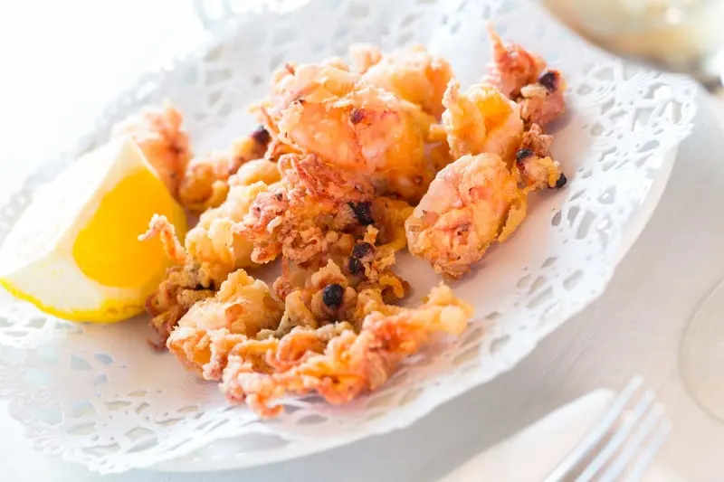 Spanish dish chipirones, small squid battered and fried, served with lemon