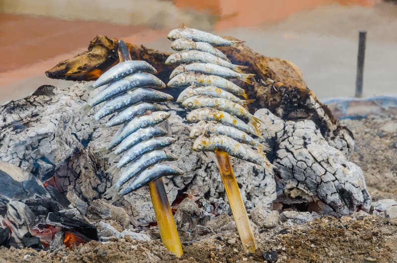 Skewered sardines cooked in the beach. Espetos