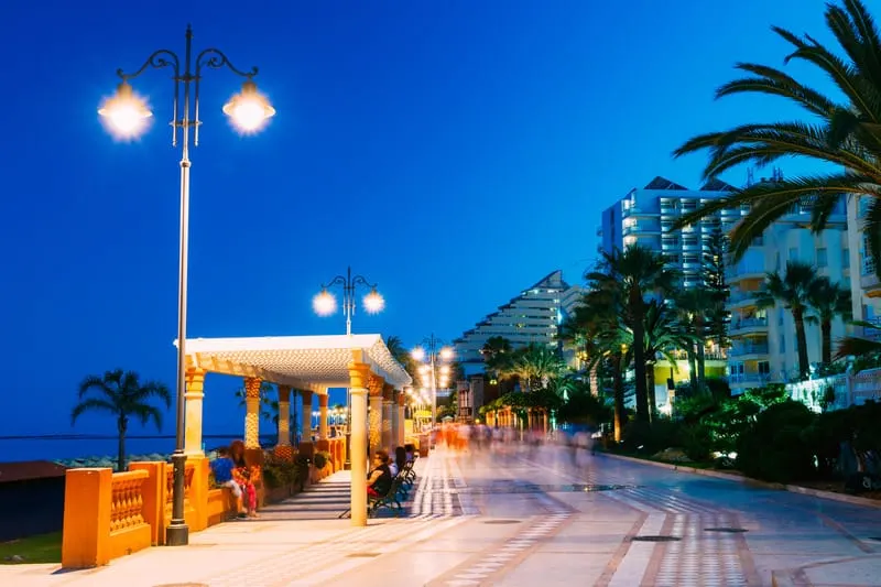 Night Scenery View Of Embankment Seacoast as one of the things to do in Benalmadena with people sitting and enjoying the view