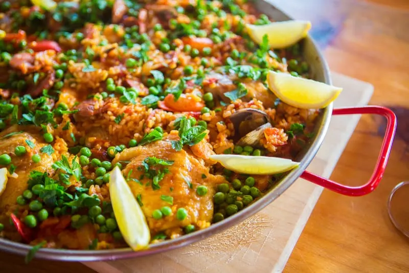 Traditional Spanish meat paella served in a paella pan.