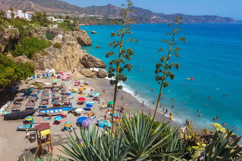 people relaxing on Maro beach filled with chairs, umbrellas