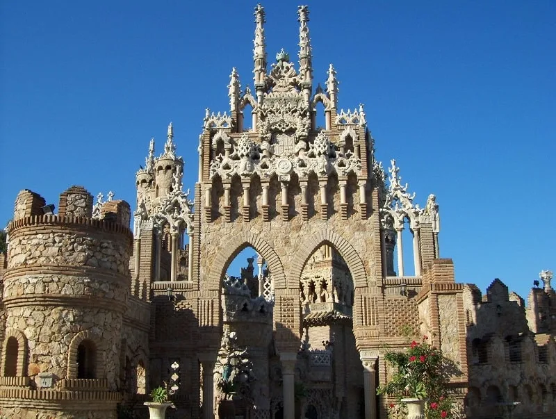 a ruins of a castle made of stone on a bright blue sky