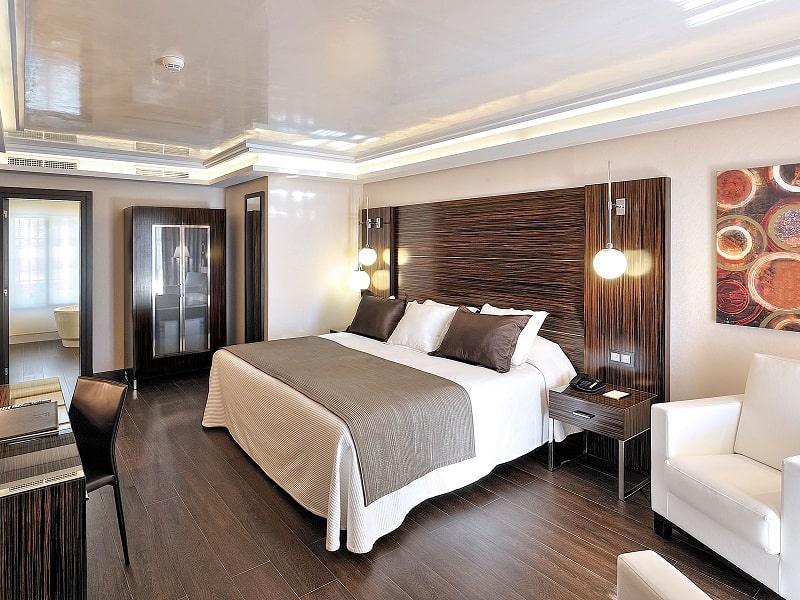 a bedroom at a hotel with brown and white accents