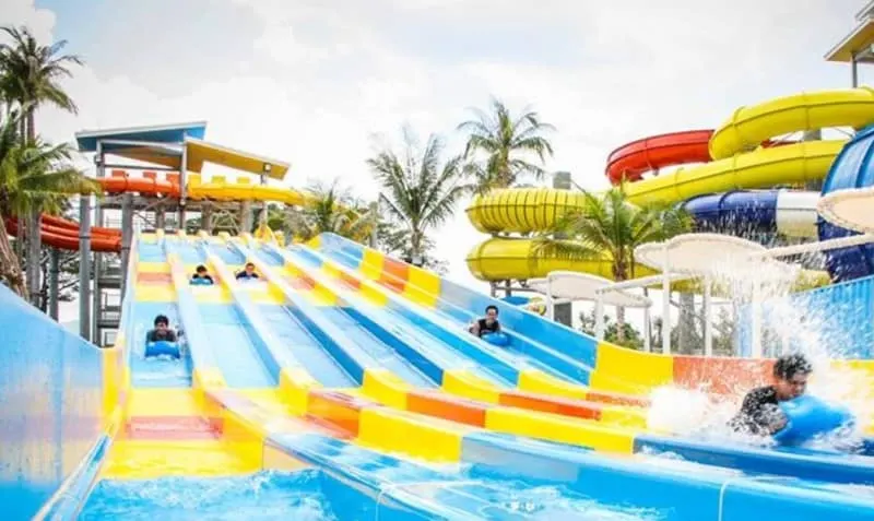 a water park with multiple slides and kids sliding down