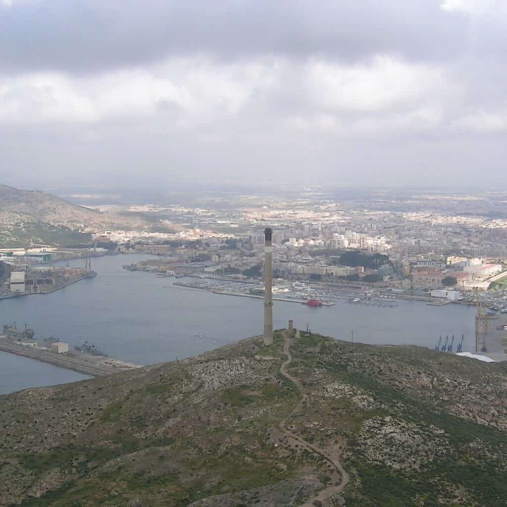 aerial view of a tower in the middle of the mountain overlooking a city