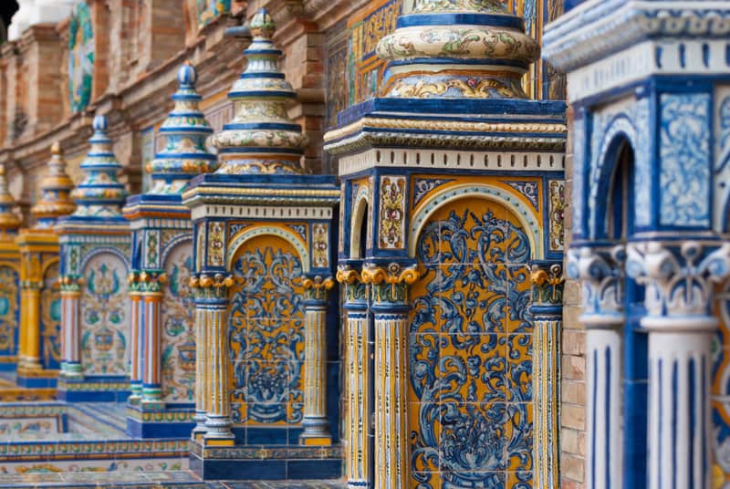 Detail of the tiled benches at the Plaza de España in Sevilla, Spain. Designed by Aníbal González for Seville's 1929 Ibero-American Expo in Andalusian regionalist style, the Plaza contains a series of Spanish glazed-tile alcoves that depict historical scenes form every province in Spain with the best places to stay in seville