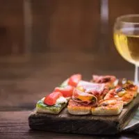 tapas and wine served on wooden board at a traditional wine and tapas tour in Seville in Winter