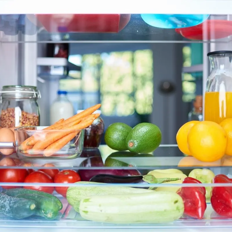 A photo with different products like fruits and vegetables in a fridge