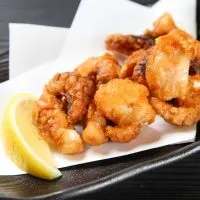 spanish fried octopus on a black plate