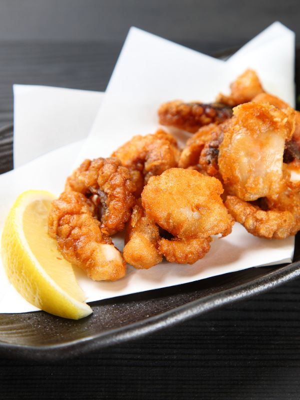 spanish fried octopus on a black plate. Deep-Fried Octopus from Spain - Pulpo Frito Recipe