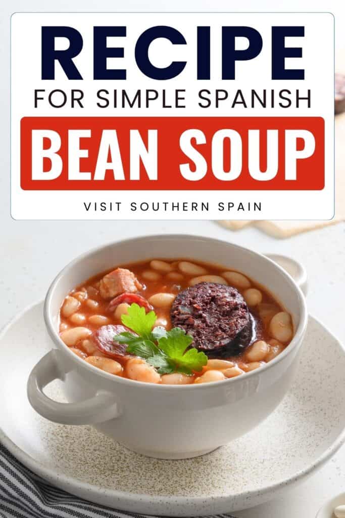 A bowl of beans with ham and blood sausage are in them. It has tomato stew.