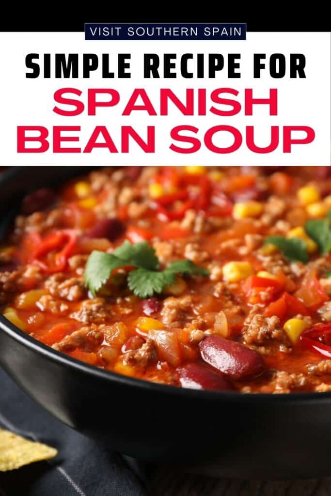 A bowl with chili made of beans, ground meat, red pepper and corn. It has some cilantro on top.