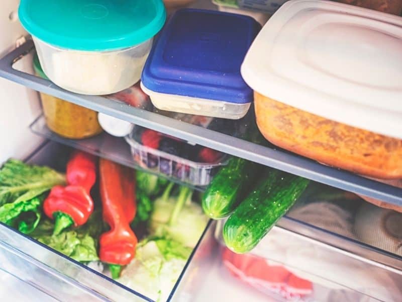 How to Store Vegetable Paella Recipe. Ingredients and plastic containers in a fridge.