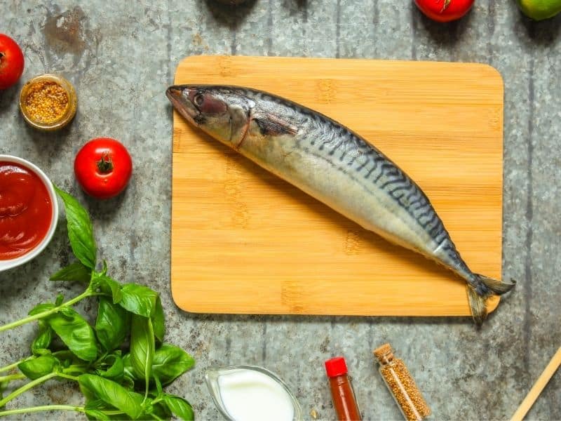 fresh mackerel on a wooden board for the salted mackerel recipe. 