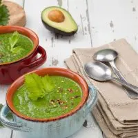 gazpacho with avocado in 2 clay bowls