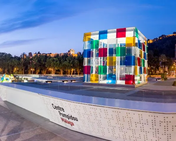 a colorful block on the Centre Pompidoul stage with lighted trees at the back 