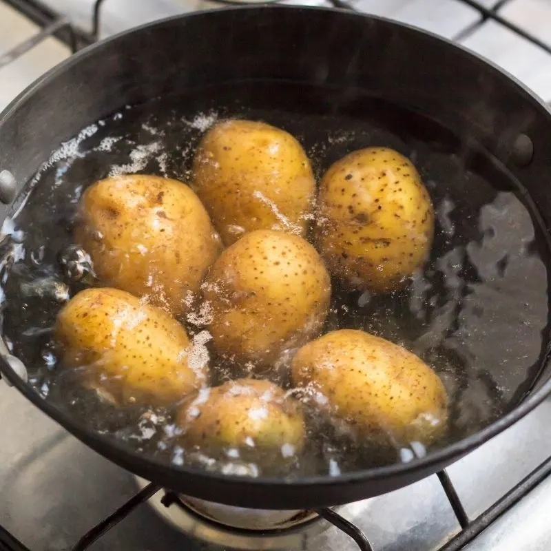 potato boiling in a pot for the papas arrugadas recipe.