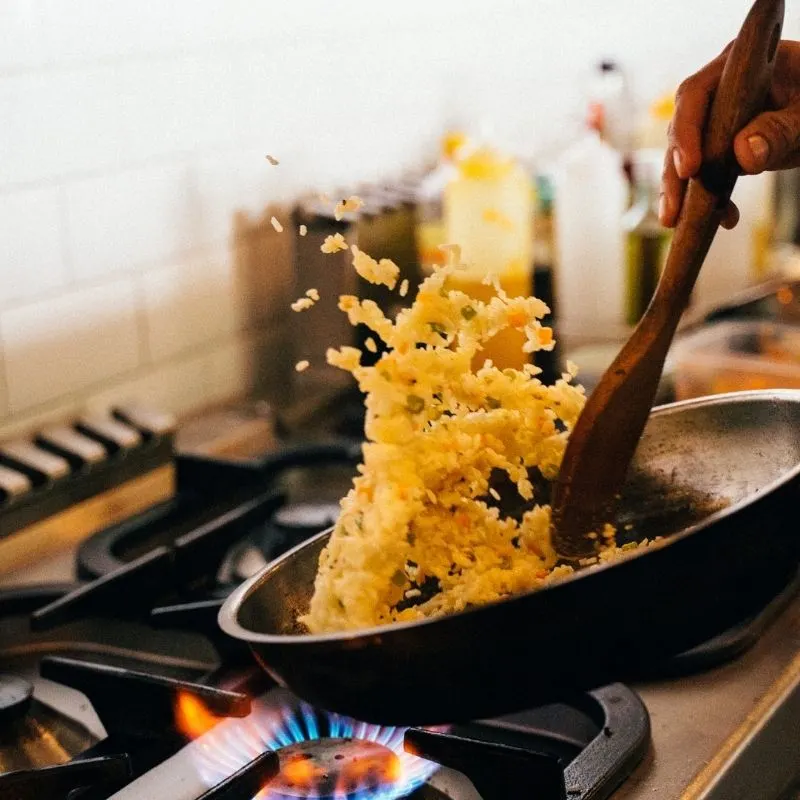 rice in a pan being cooked on the stove.