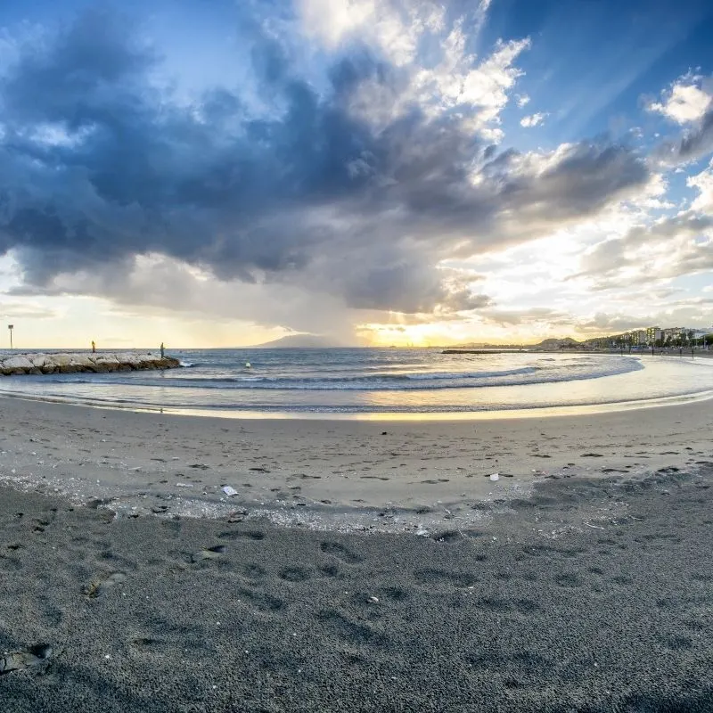 a sandy beach during a sunset with a cloudy sky - Playa de el Palo, Malaga