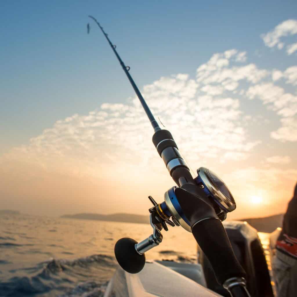 a fishing rod on a boat at sunset