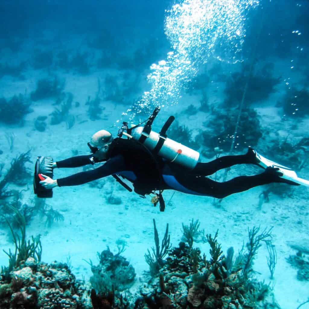 a person using an underwater scooter while diving in the ocean
