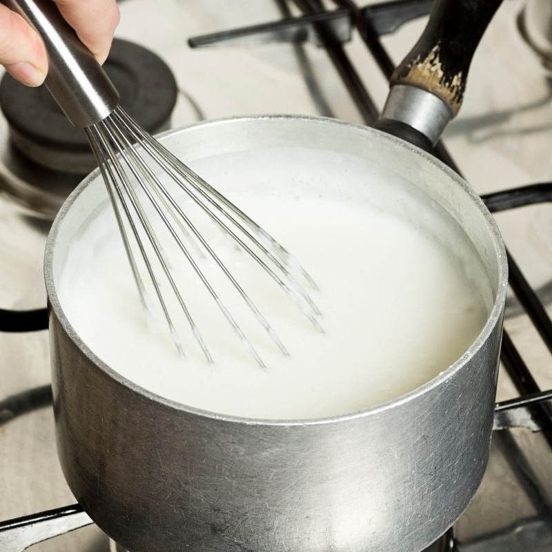 milk boiling in a pot for the spanish natillas de leche.