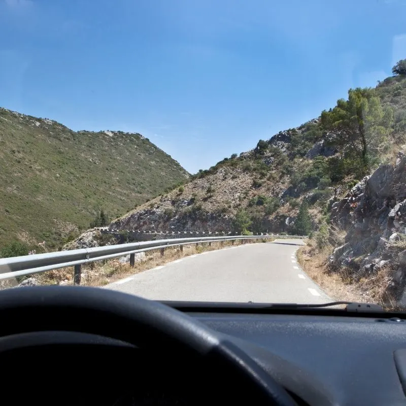 A spanish road through the mountains from a driver's point of view, traveling from Granada to Malaga