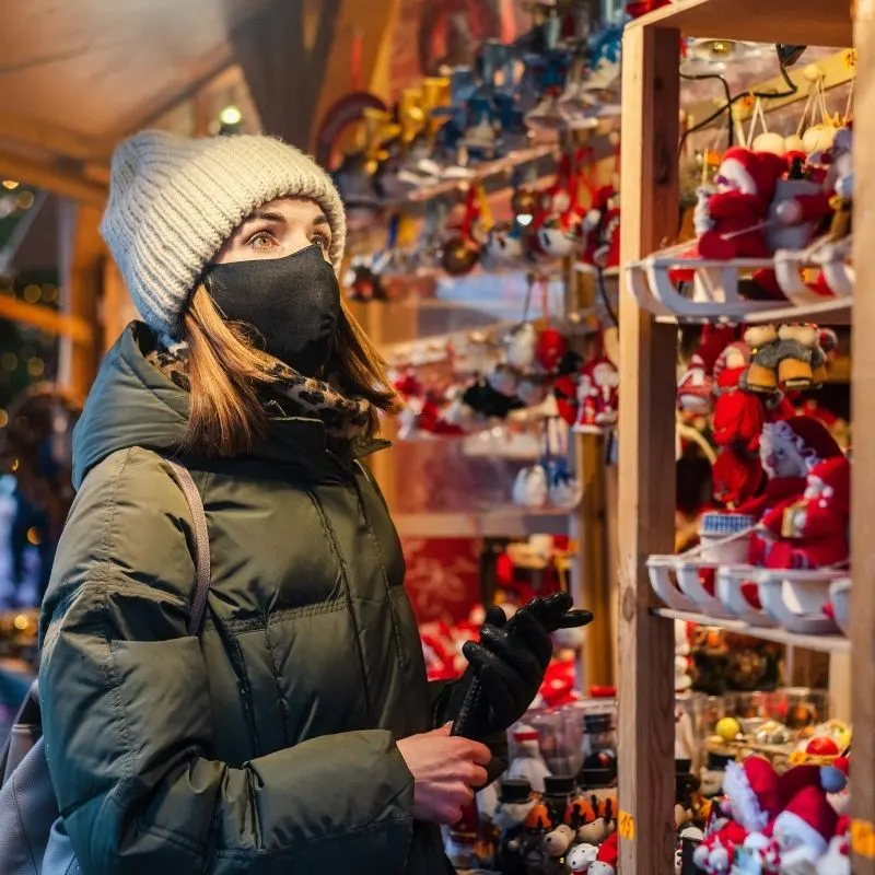 girl buying souvenirs at a Christmas Market In Malaga