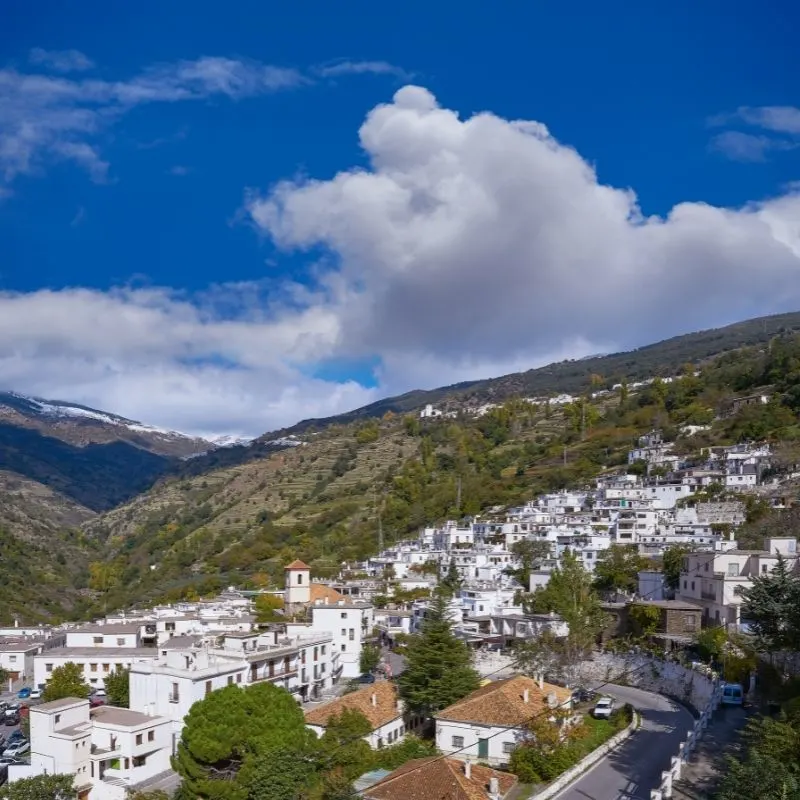 Pampaneira - the Whitewashed Alpujarras Village on a mountain on a bright cloudy day