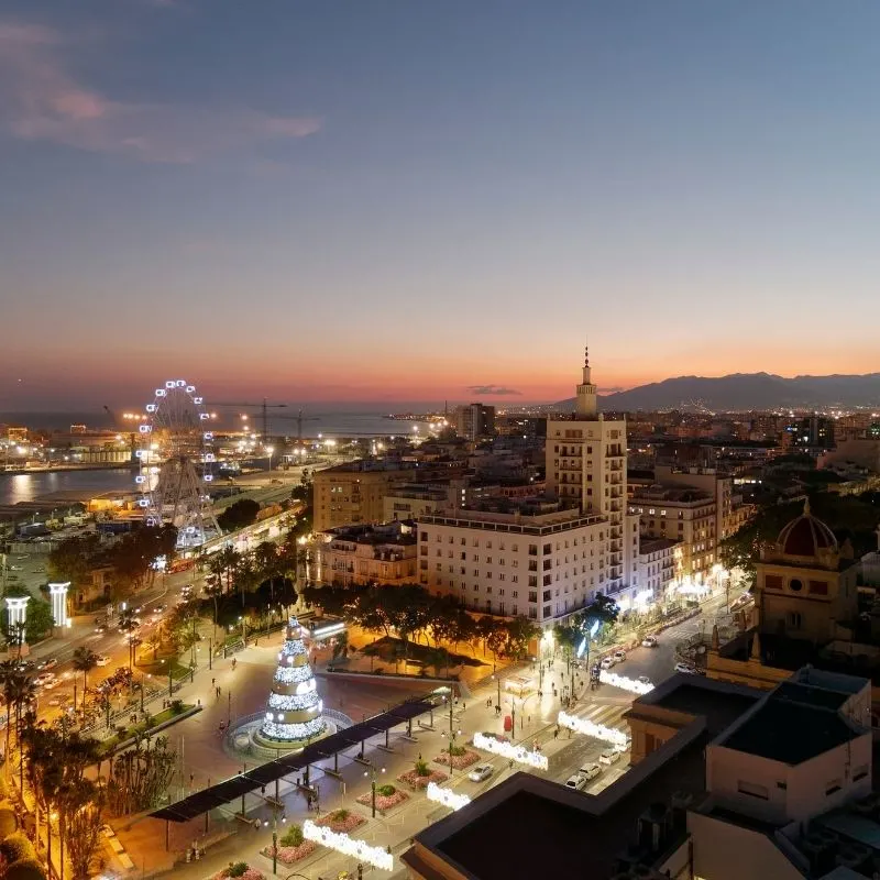 aerial view of Malaga in Winter during Christmas with christmas lights during dusk time