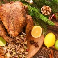 top view of christmas turkey on a wooden plate with sides like lemon