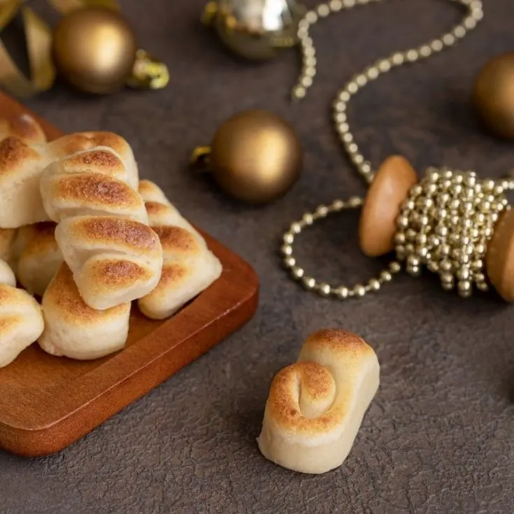 marzipan candy that looks like tiny bread with christmas decorations on the side