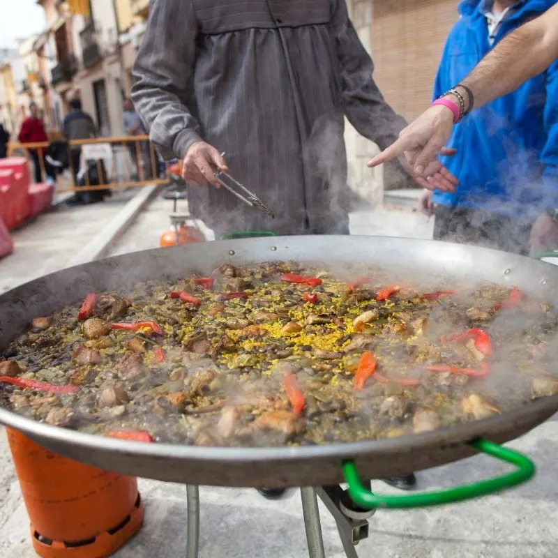 food tour in Marbella, a big authentic paella being cooked