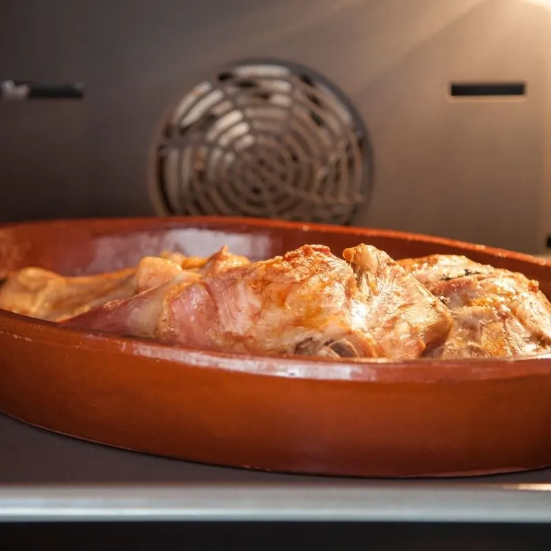 spanish pork in a pot baking in the oven
