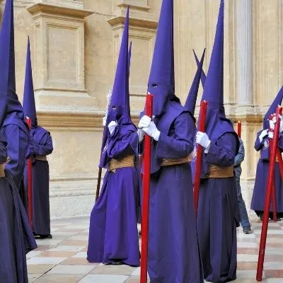 members of the brotherhood dressed in blue or purple Nazarenos