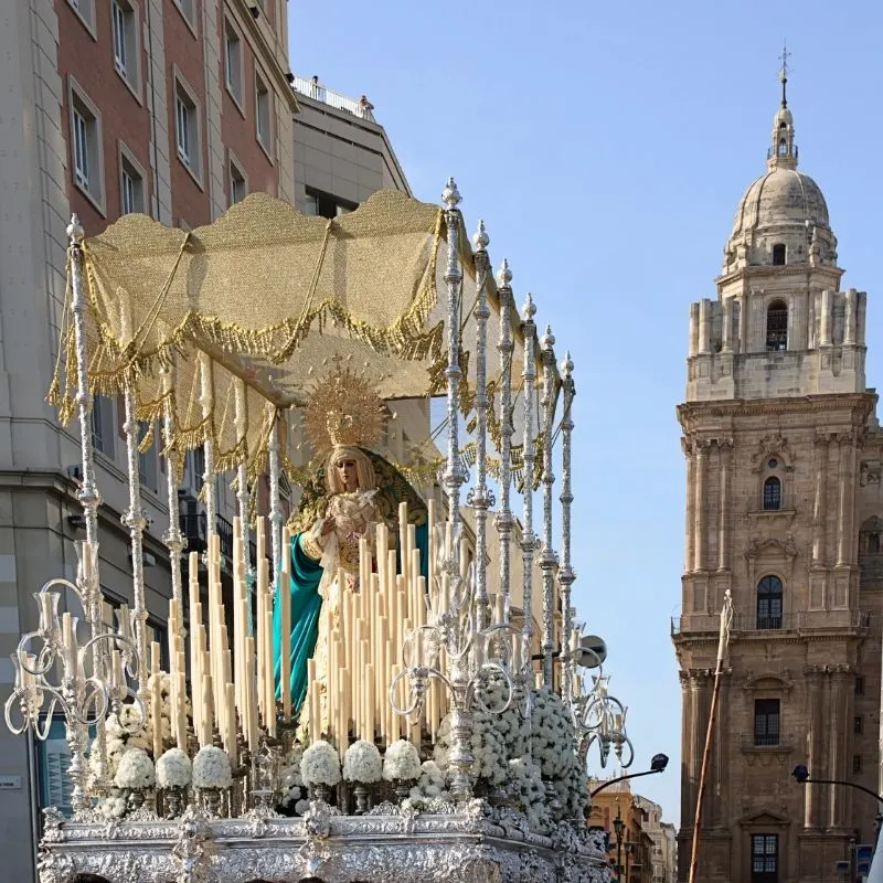 a big statue being carried on the streets of spain, what is the history of semana santa