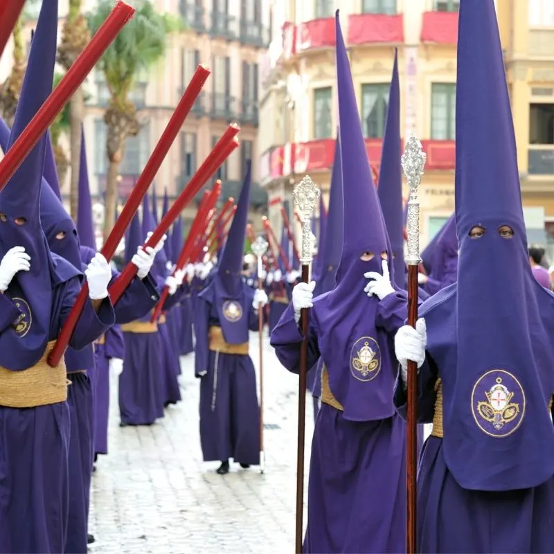 Semana Santa in Malaga, people with blue robes parading the city, what is the history of semana santa