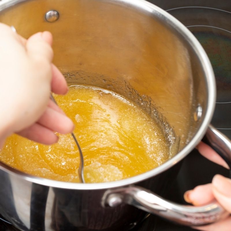 preparing honey syrup in a pan for the Spanish turron