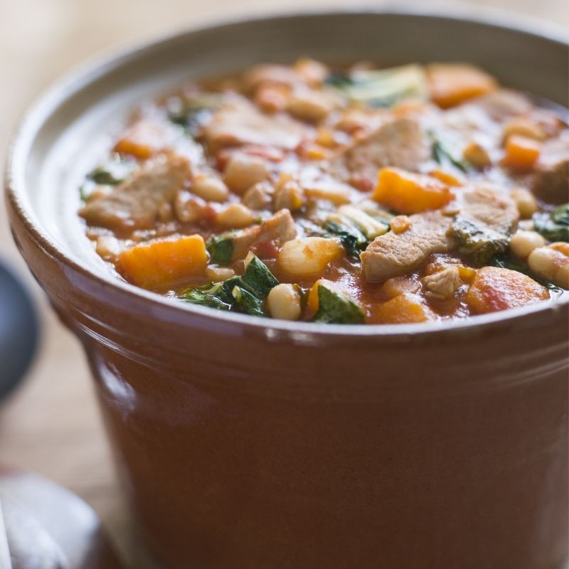 closeup with Spanish lamb stew in a clay pot