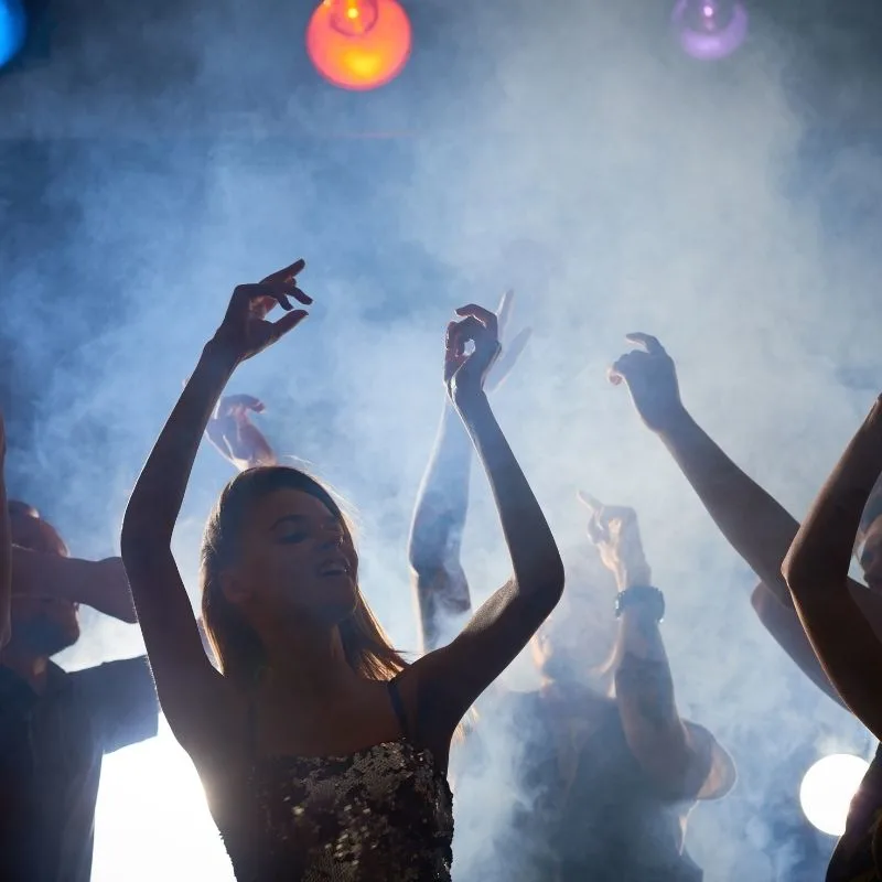 people dancing in the Uthopia nightclub with smoke and lights