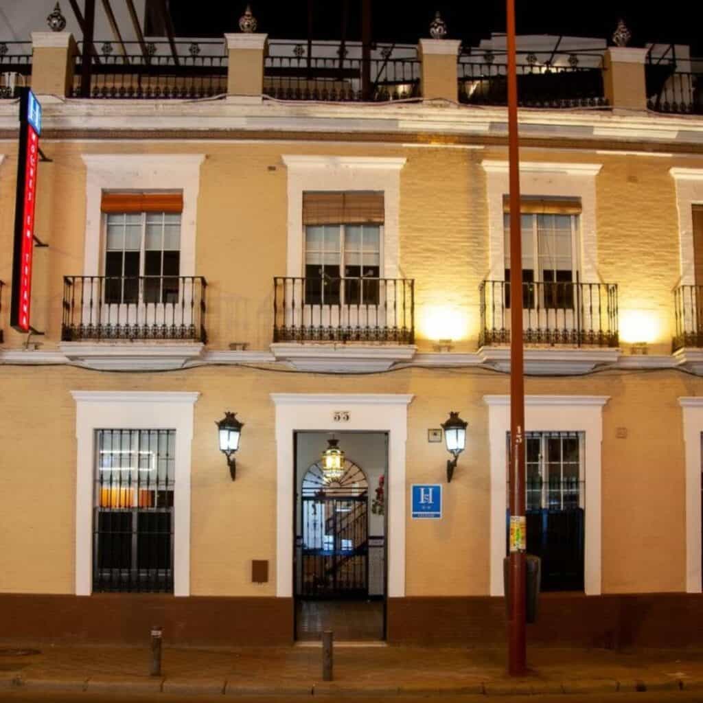 a facade of a yellow building of the Noches en Triana